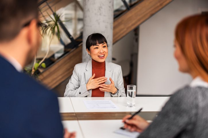 Person speaking during a business meeting.